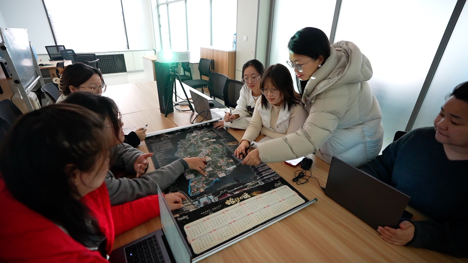 地圖設計師宇文春培正在帶領團隊討論設計方案。張超寧 攝。
